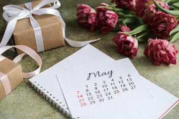 May calendar, gift boxes and tulips bouquet