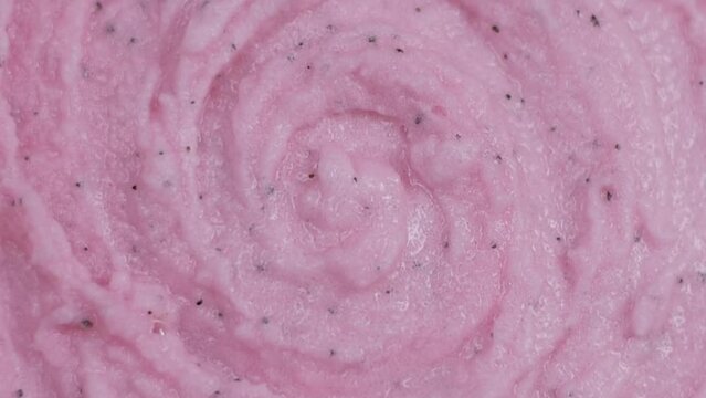 Smears of cosmetic pink scrub rotating top view. Beauty background flat lay .Close up4K