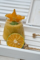 orange and star fruit smoothie in a clear glass. fruit drinks that contain vitamin C, fiber, and...