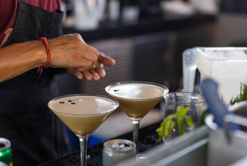 A bartender makes an espresso martini at a beach bar in the Maldives