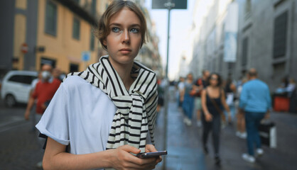 Fototapeta premium Portrait of teenage girl in crowded city.