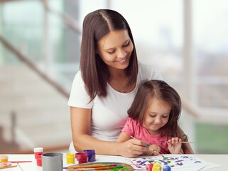 Happy young mom study with kid