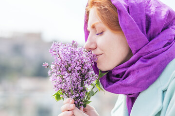 Bouquet of lilac  in female hands. 
Mothers Day. 