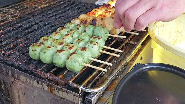 Original dango and green tea skewers grilled on japanese style stove.