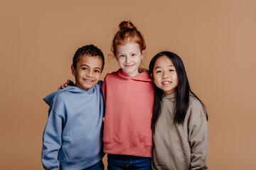 Portrait of three children, studio shoot. Concept of diversity in friendship.