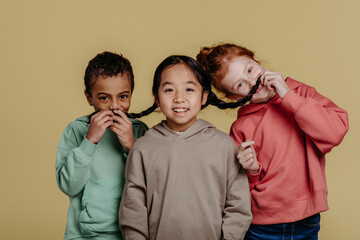 Portrait of three children, studio shoot. Concept of diversity in friendship.