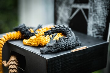 Closeup of 3D printed dragons in gold and black