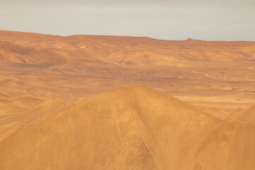 Fototapeta na wymiar sunrise in the desert with clouds and sand