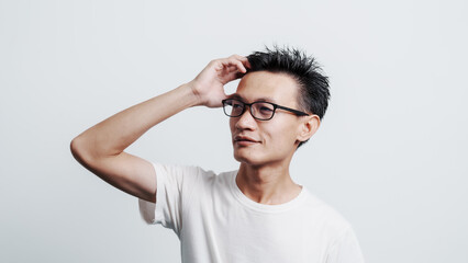 Young confident asian chinese young man checking hair style and dandruff.