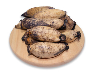 Lotus roots on a round wooden cutting board isolated on a white background with clipping path.
