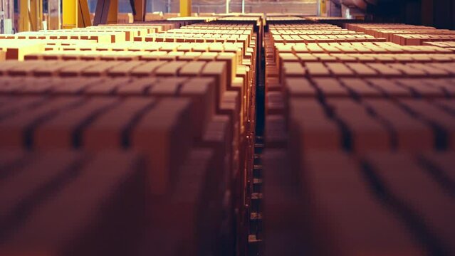 Focus movement shot. Full warehouse of bricks. Stocked before firing process. Layed in special manner. Vintage. Epic effect. Slow motion 50perc. 4k.