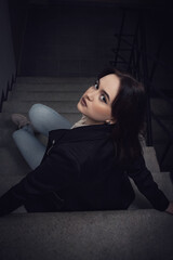 Young girl on the stairs at home.