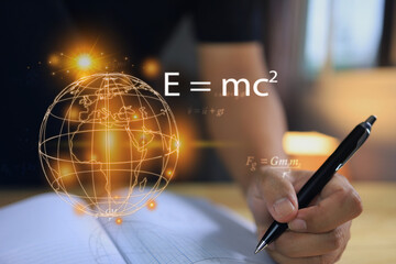 Physics equations floating around globe, hands writing in notebooks over the book, representing the learning teaching or scientific notes of Albert Einstein and Sir Isaac Newton or physics law.