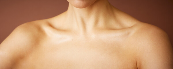 Neck and shoulders on brown nude background for beauty and jewelry