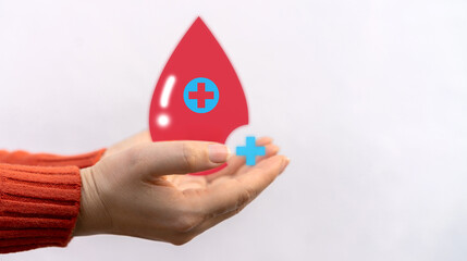 Hand holding red heart and blood drop donation, save life, world hemophilia day concept, world blood donor day, hospital, life and health insurance, world mental health day