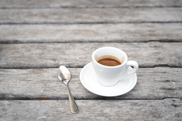 small white coffee cup on grey grunge wooden table