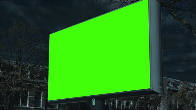 Night Billboard Green Screen Outdoor Stand Street Panel Cloudy Sky Background. Low angle shot of an outdoor billboard green screen on a cloudy night. Steady shot