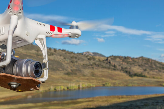 FORT COLLINS, CO, USA, September 30, 2014:  Airborne radio controlled DJI Phantom quadcopter drone with Panasonic Lumix GM1 camera (home made mount).