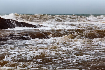 View of the volcanic shore of the stormy Atlantic Ocean in the area of Essaouira in Morocco.