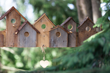 Wooden birdhouses stylish decoration at the entrance to the eco park. Manufacture of wooden products, hello spring, wooden decor. Realty, social housing concept.