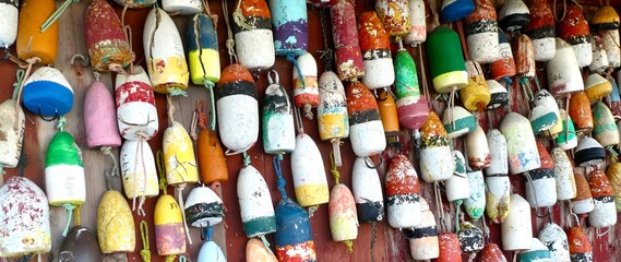 A collection of colorful marine floats hanging on a wall.