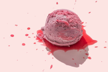 berries ice cream scoops with juicy icing on pink background, creative decoration, summer concept