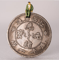 Chinese coin with a miniature human figure