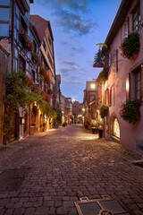 Fototapeta na wymiar Vertical shot of Sunset in the streets of Riquewihr, Alsace, France