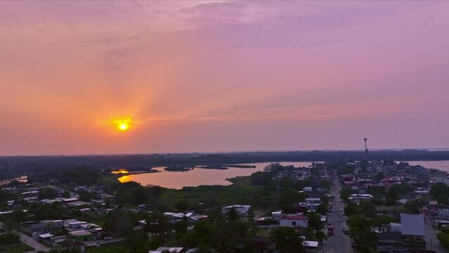 Drone made sunset with the sun still in frame and reflections on water HLG edited