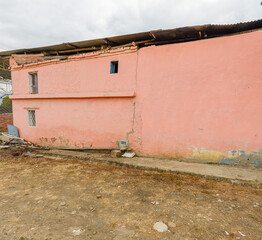 Pink/Salmon colored wall on a rural house