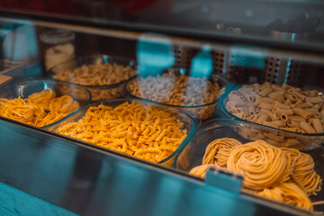 Traditional Italian fresh made colorful organic pasta in shop window. Italian food at a farmer's market in Pisa, Italy.
