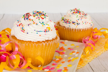 Vanilla cupcake dessert with rainbow colored sprinkles topping
