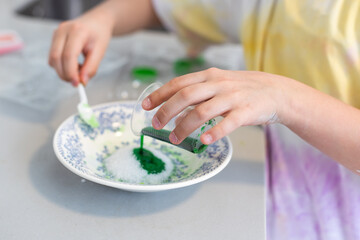 Children are learning and doing science experiments. Little girl playing science experiment for home schooling. Easy and fun science experiments for kids at home.
