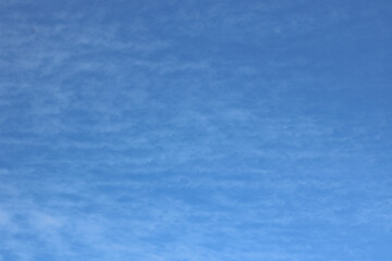 Fototapeta na wymiar Full frame of pretty blue sky with soft scudding cloud formation