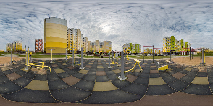 360 hdri panorama view outdoor exercise equipment gym among modern residential complex with skyscrapers and high-rise buildings in equirectangular spherical projection ready VR virtual reality content