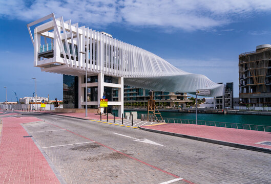 Twisting helix design of Dubai Water Canal bridge over the waterway to apartment blocks