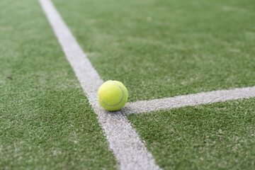 tennis ball on tennis grass court