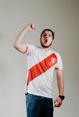 Photograph of Peruvian fan celebrating a goal of his team. Concept of people, emotions and sports.