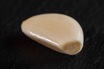 Garlic cloves. Raw garlic isolated on black background. Vegetable