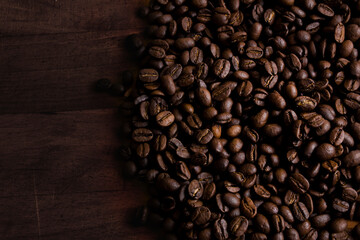 Coffee beans on a wooden wall background. Coffee as the start of the day.