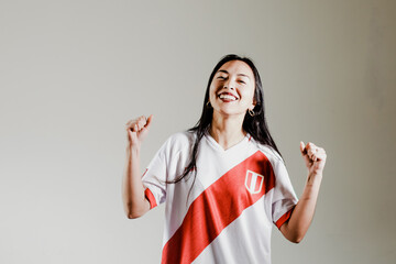 Photograph of Peruvian fan woman celebrating a goal of her team. Concept of people, emotions and...