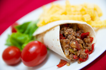 Wrapped minced meat with salad and potato chips