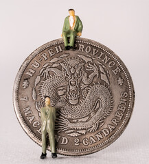 Chinese dragon coin with 2 miniature human figures