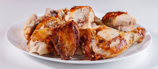 Sliced fried chicken on a white plate