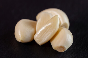 Garlic cloves. Raw garlic isolated on black background. Vegetable