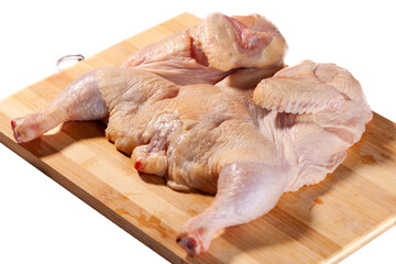 Raw chicken on a wooden board isolated on white background ready for cooking
