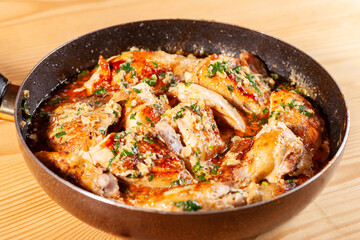 Shkmeruli, chicken in garlic sauce on a frying pan