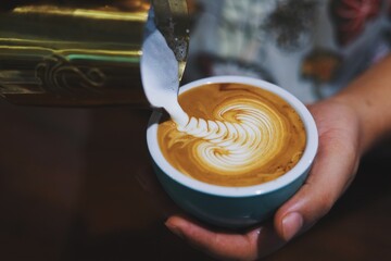 pouring coffee into a cup