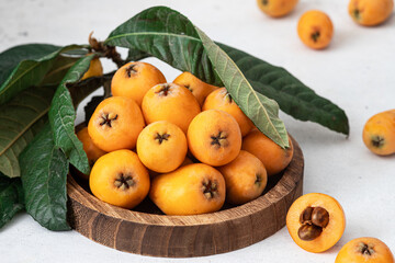 Loquats on a basket on background
