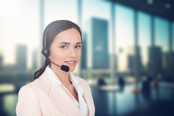 Young woman working wearing a headset in a call centre.